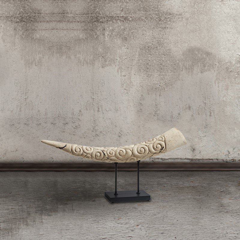 Elephant tusk statue with black base